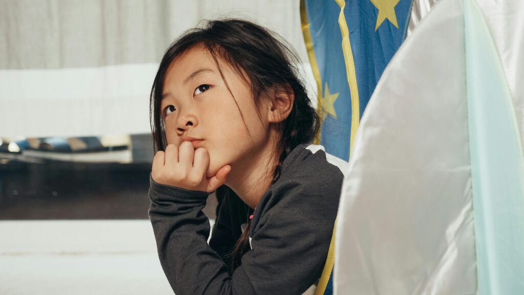 Young girl lost in thought, symbolizing early reflection on finding your life purpose.