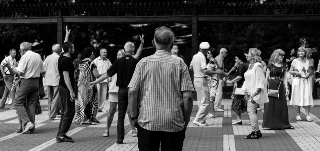 A person feeling lonely in a crowd, symbolizing the emotional need for kindness and connection.