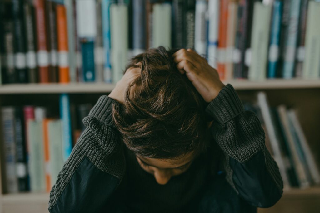 "Stressed student struggling under pressure in the Indian education system"