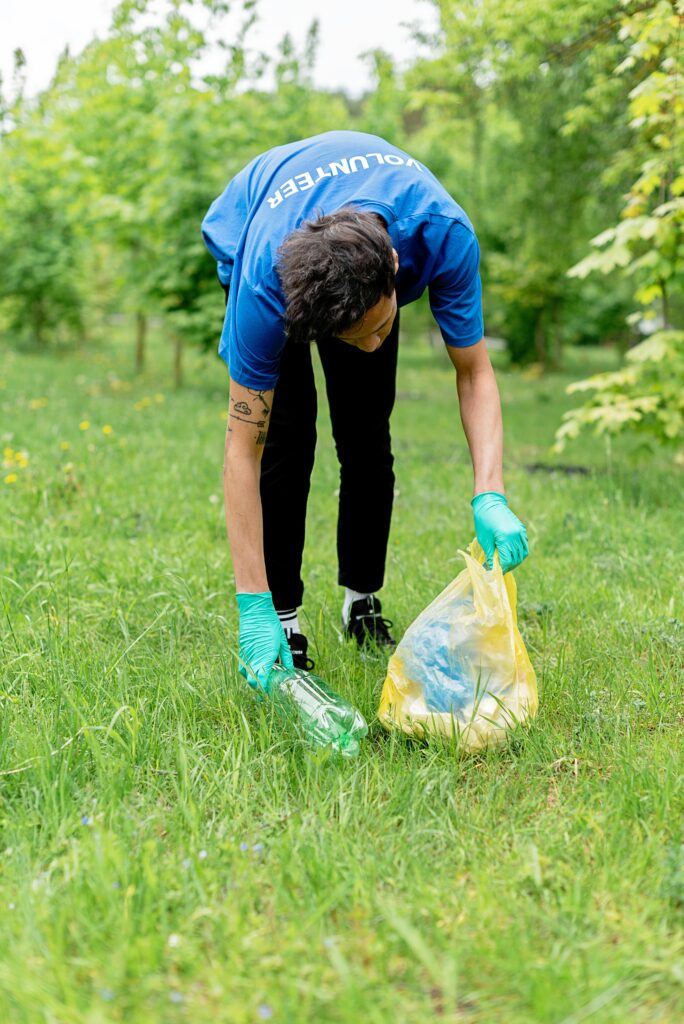 A volunteer cleaning a park to promote civic sense in India through responsible action