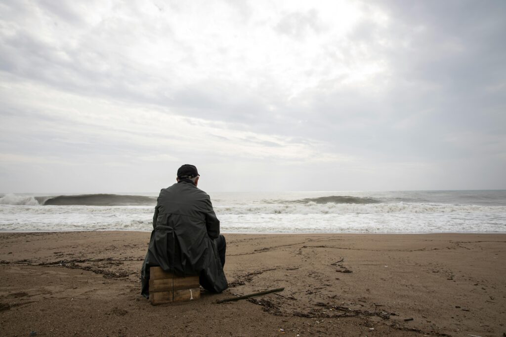 Lonely person reflecting on life after gossiping, showing emotional impact and isolation.